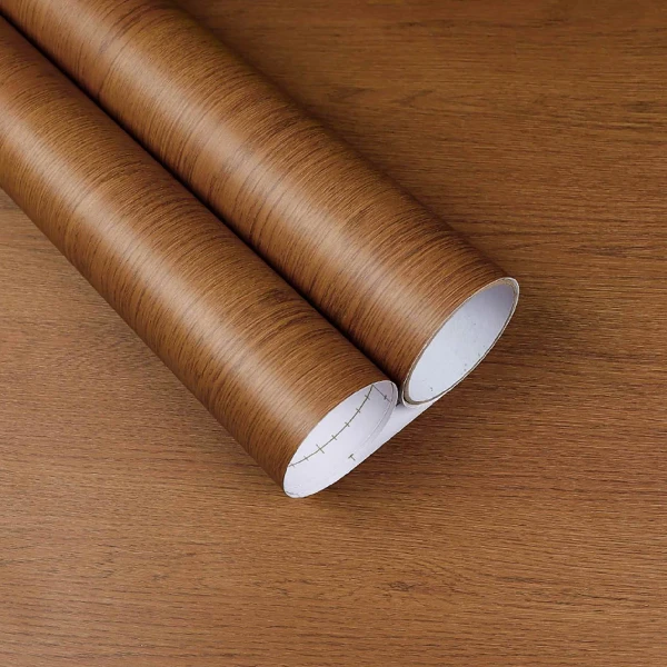 A roll of dark brown wood grain patterned vinyl wrap.