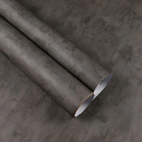 A roll of dark gray concrete or stone-textured vinyl wrap. (1)