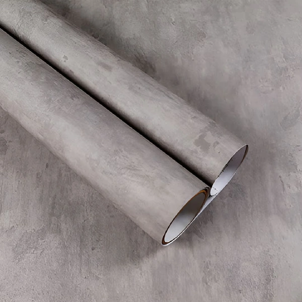 A roll of gray concrete or stone-textured vinyl wrap. (1)