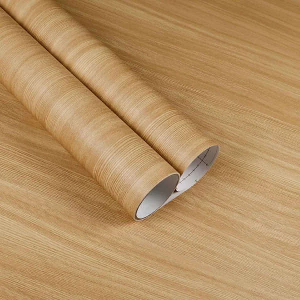 A roll of light brown wood grain patterned vinyl wrap. (2)