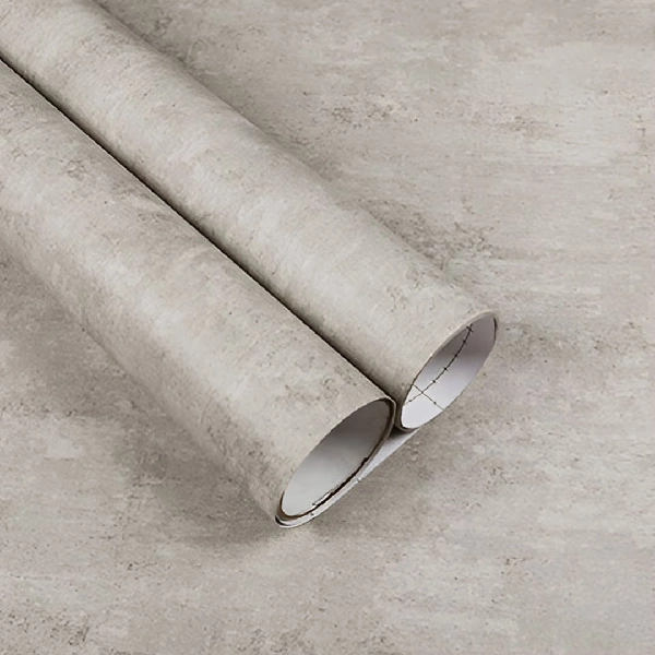 A roll of light gray concrete or stone-textured vinyl wrap. (1)