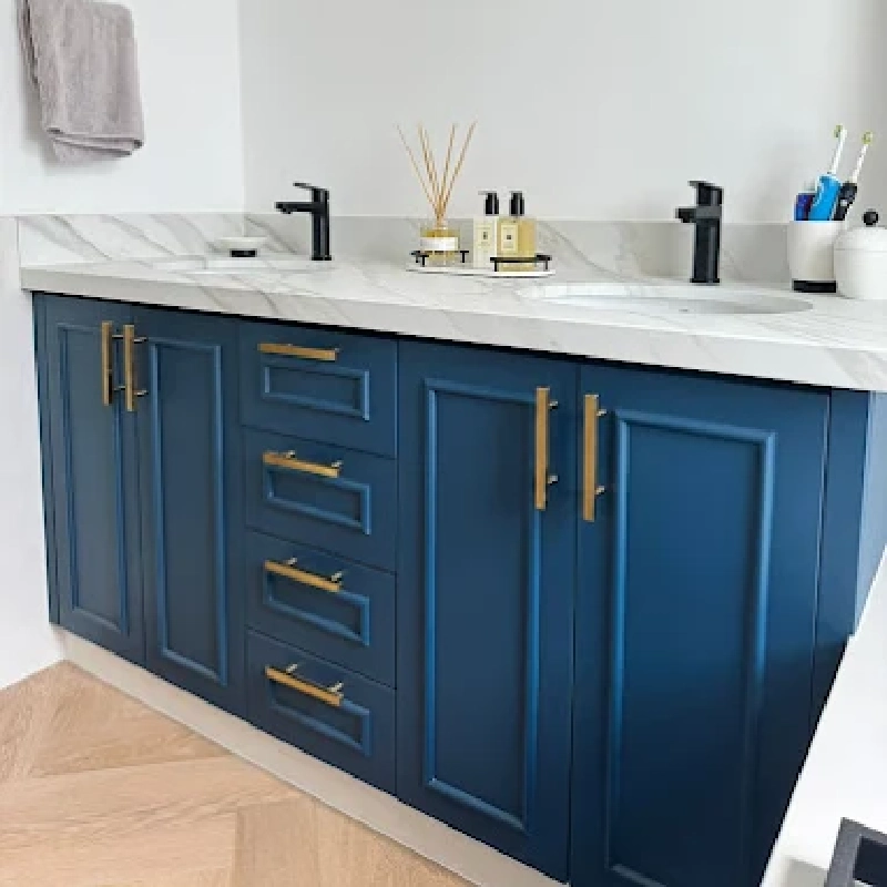 Bathroom vanity with a blue vinyl wrap on the cabinets and a marble-patterned vinyl wrap