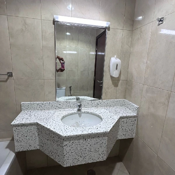 Bathroom with a sink and a terrazzo-patterned vinyl wrap
