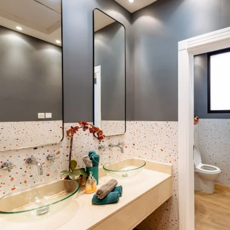 Bathroom with a terrazzo-patterned vinyl wrap on the lower half of the walls.