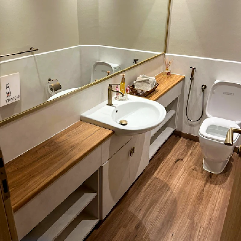 Bathroom with a vanity and a light woodgrain vinyl wrap on the countertop