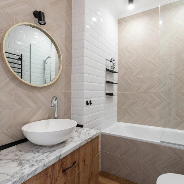 Bathroom with a white marble vinyl wrap on the countertop and woodgrain vinyl wrap