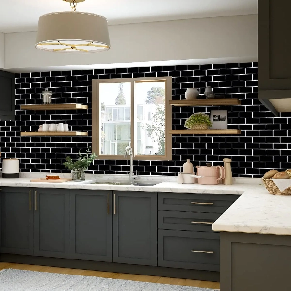 Black adhesive subway tile backsplash with white grout.