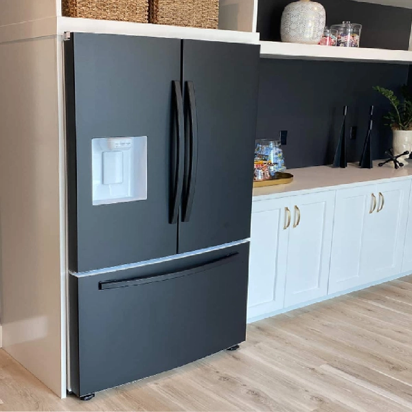 Black appliances wrapping on a refrigerator. (1)