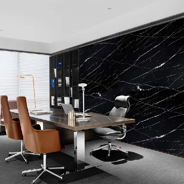 Black marble-patterned vinyl wrap with white veins on a wall in a modern office.