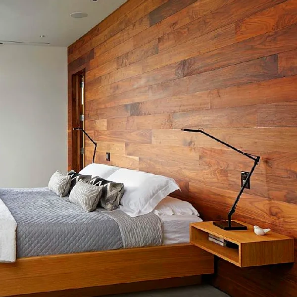 Dark wood-paneled wall vinyl wrap behind a bed.