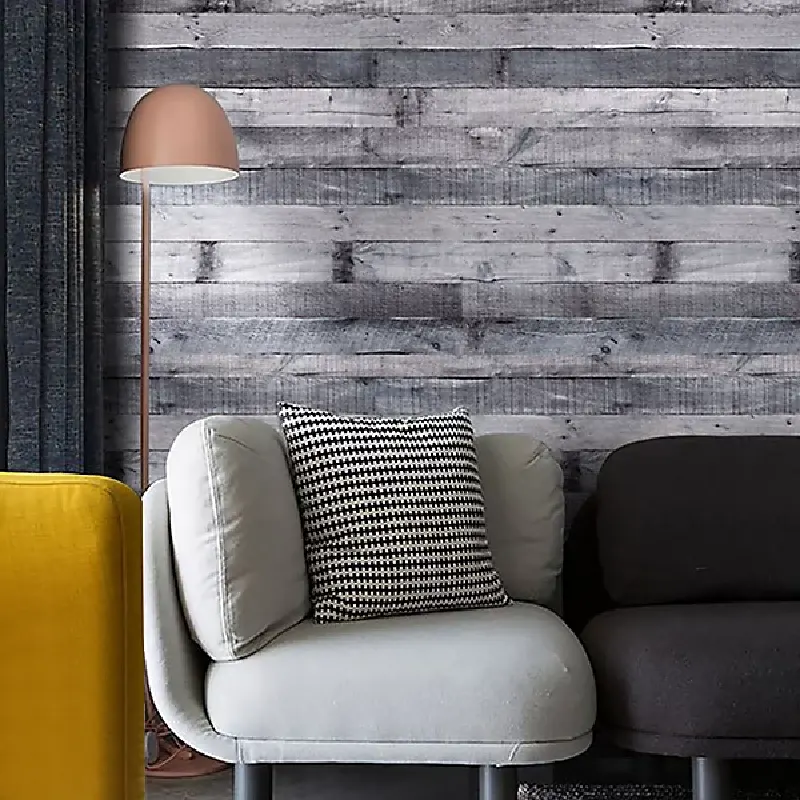 Distressed grey-and-white, wood-panel vinyl wrap on a wall.