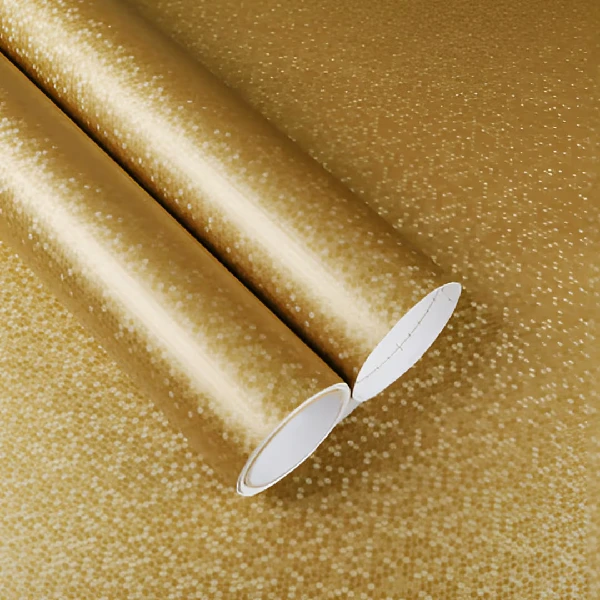 Golden textured vinyl wrap rolled out on a surface.