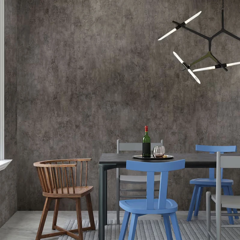 Gray distressed concrete look vinyl wrap on a wall in a restaurant.
