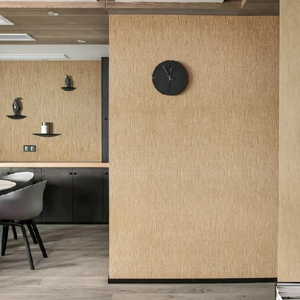 Light-brown textured vinyl wrap on a wall, with a black clock and shelves.