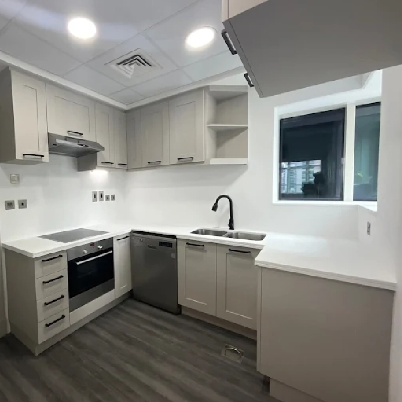 Light gray kitchen cabinets with a vinyl wrap finish.