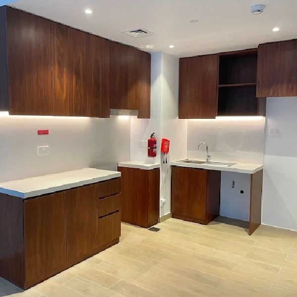 Medium-toned wood grain vinyl wrap on kitchen cabinets.