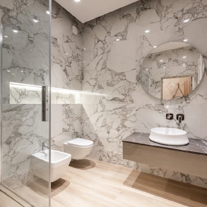 Modern bathroom with white marble vinyl wrap on the walls.