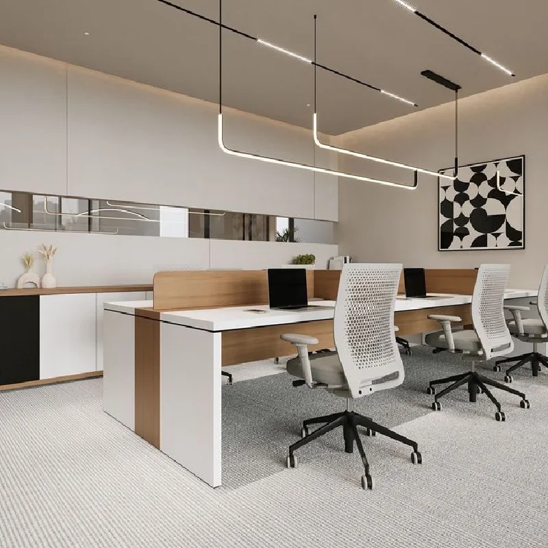 Modern office with white and wood desks and ergonomic chairs.