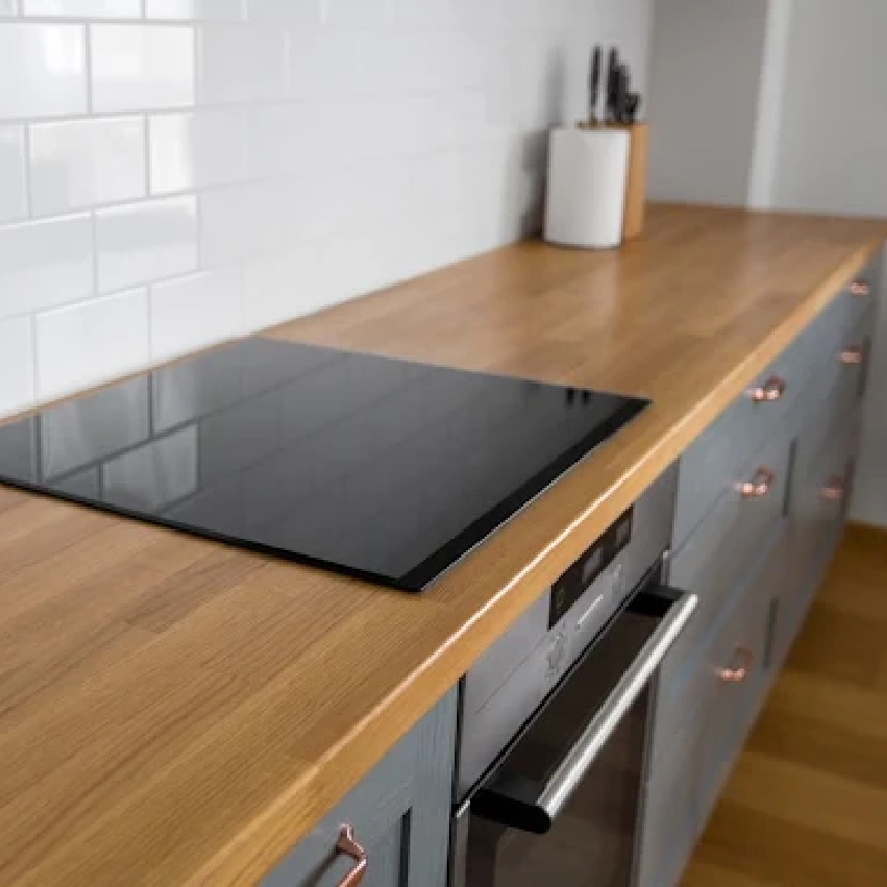 Oak-look vinyl wrap on a kitchen countertop.
