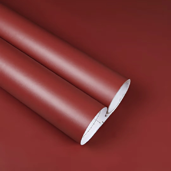 Rolls of dark red solid vinyl wrap.