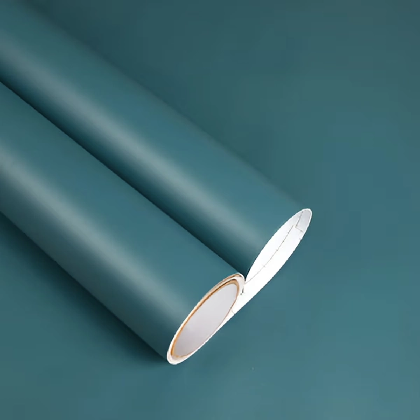 Rolls of dark teal solid vinyl wrap.