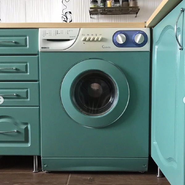 Teal appliance vinyl wrap on a washing machine.
