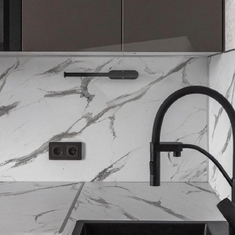 White marble-patterned vinyl wrap with prominent grey veins on a kitchen backsplash.