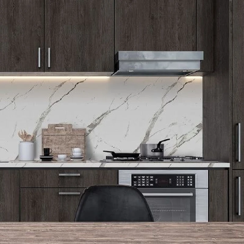 White marble-patterned vinyl wrap with thin grey veins on a kitchen backsplash.
