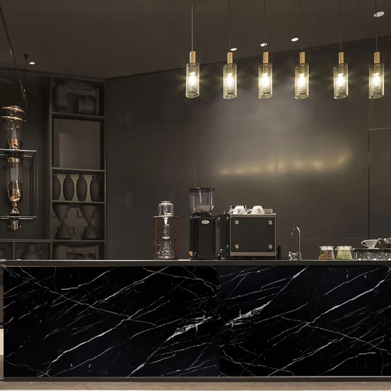 kitchen cabinets with a black marble patterned vinyl wrap countertop.