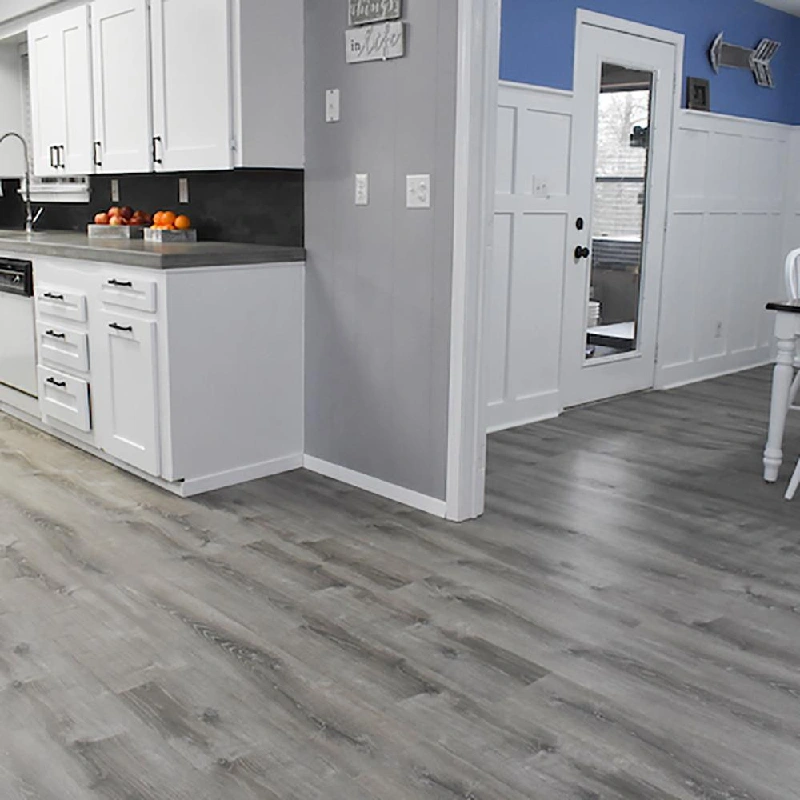 kitchen with a grey, wide-plank vinyl floor wrap with a faded wood grain