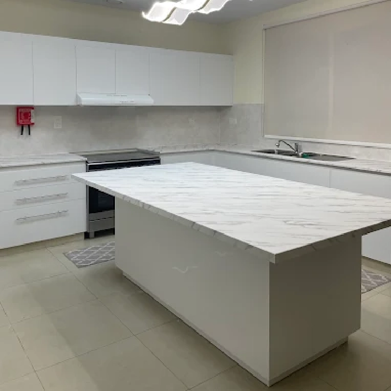 white marble-patterned vinyl wrap countertop, and matching countertops and cabinets.