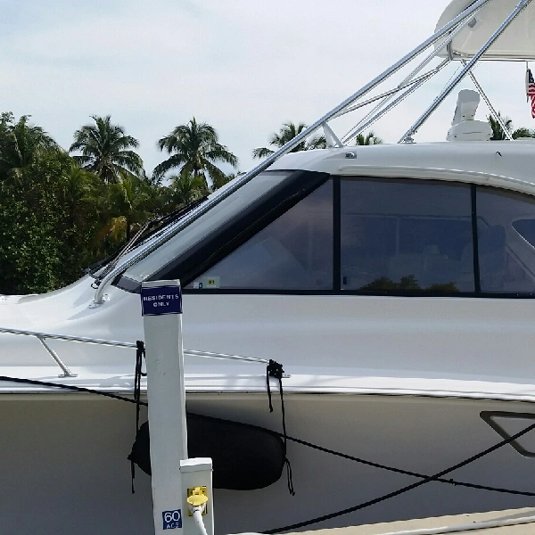 white yacht with a dark window tint vinyl wrap on its front windows